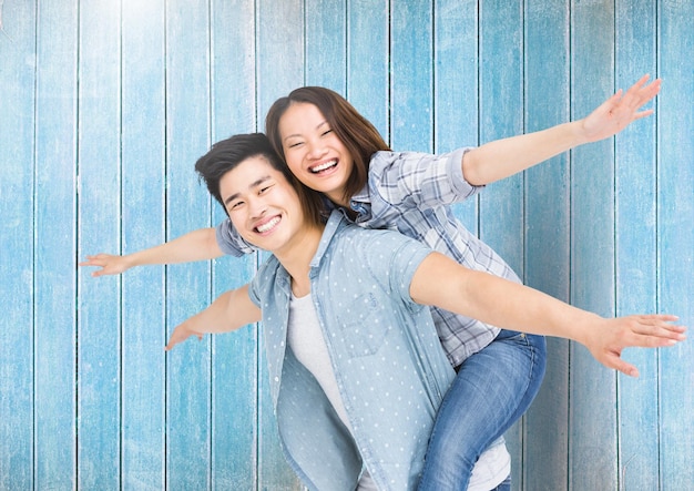 Happy man giving woman piggyback