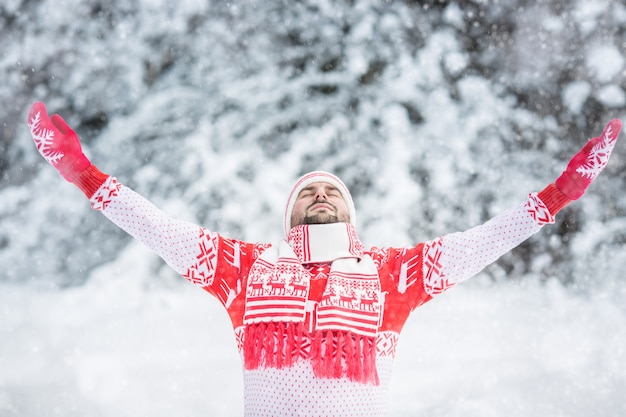 Happy man having fun in winter park