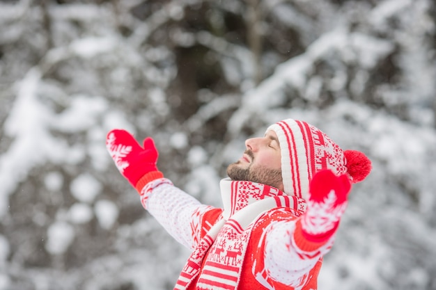 Happy man having fun in winter park