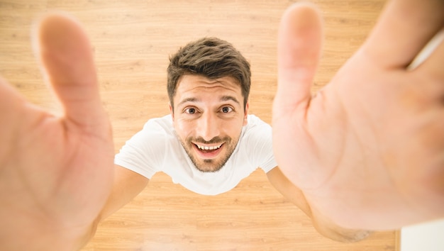 The happy man hold a camera. view from above