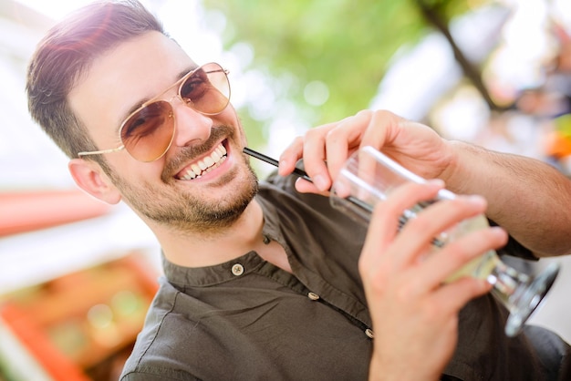 Happy man holding cocktail