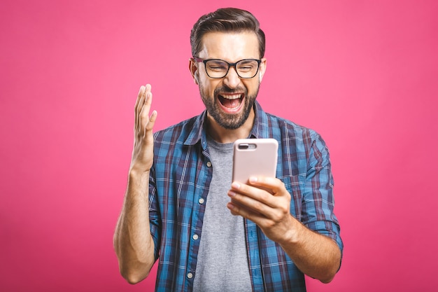  Happy man holding smartphone and celebrating his success