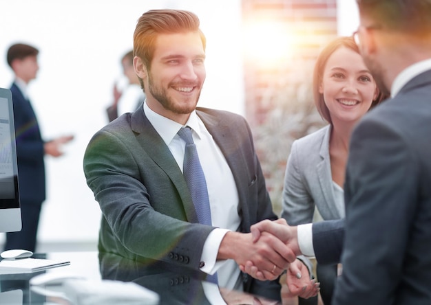 Happy man introducing businesswoman to business partners