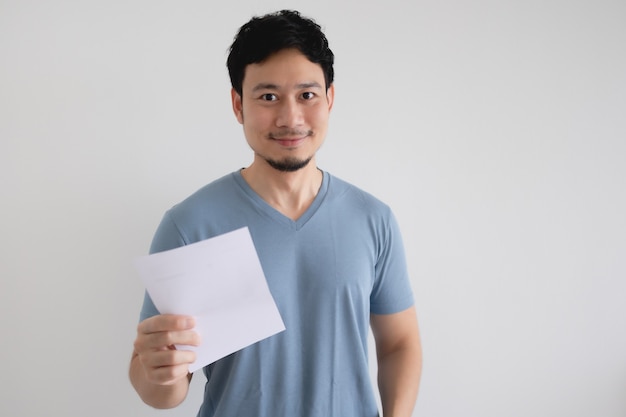 Happy man is holding an invoice letter on isolated white background.