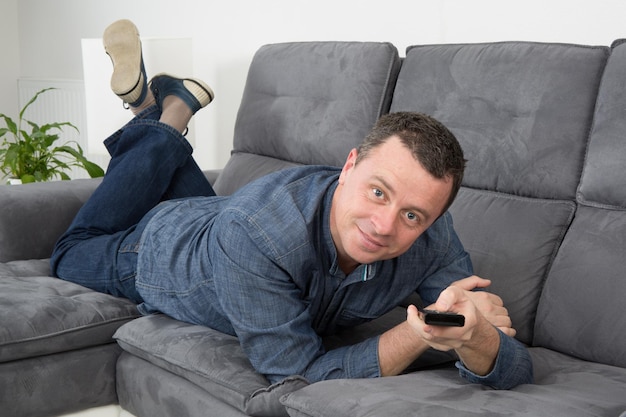 Happy  man lying on a couch