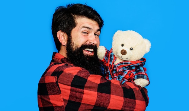 Happy man in plaid shirt with teddy bear bearded guy with plush toy birthday gift and present