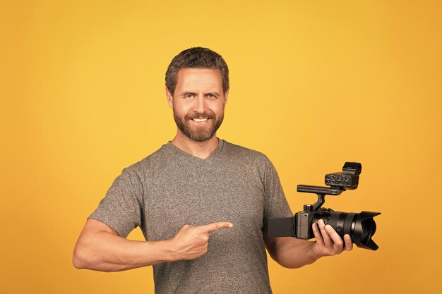 Happy man point finger on camcorder videographer making video movie maker make vlog