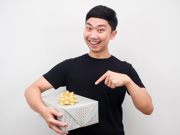 Happy man point finger at gift box in his hand