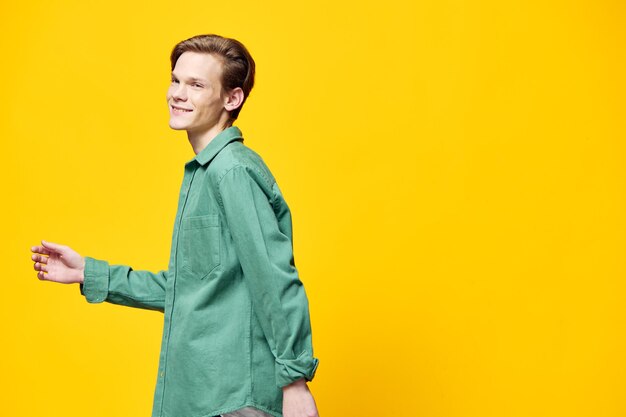 Happy man posing on yellow background with space for text