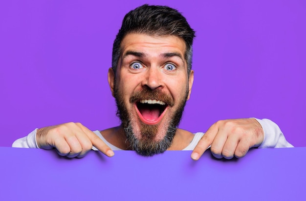 Happy man presenting empty advertising banner bearded guy shows blank sign board