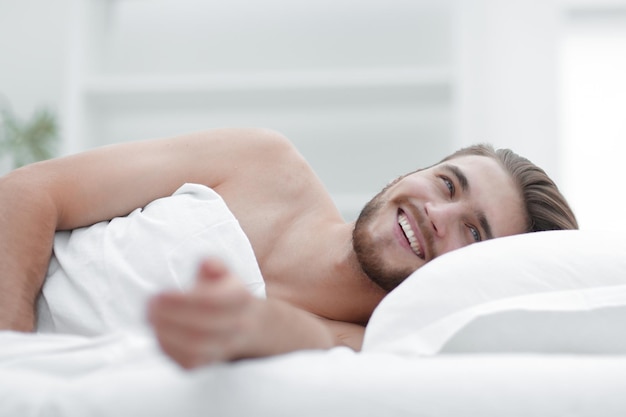 Happy man relaxing in a cozy roomphoto with copy space