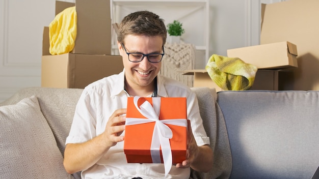 A happy man satisfied by a quick delivery unpacking of order from online shops