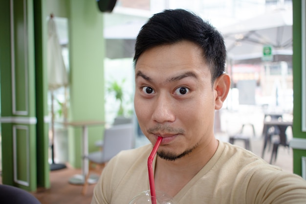 Happy man selfie himself in the coffee cafe.