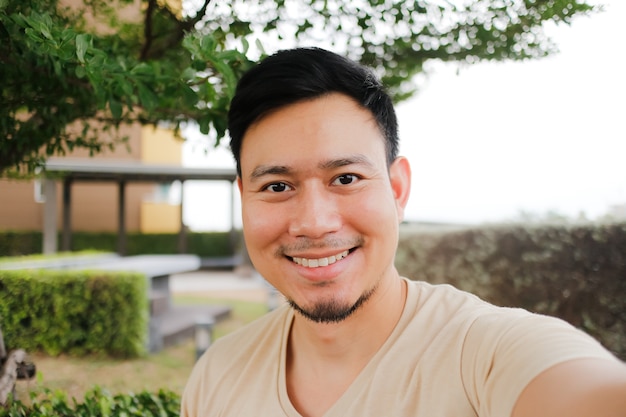 Happy man take selfie of himself smiling.