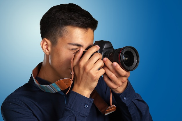 Happy man taking pictures with digital camera