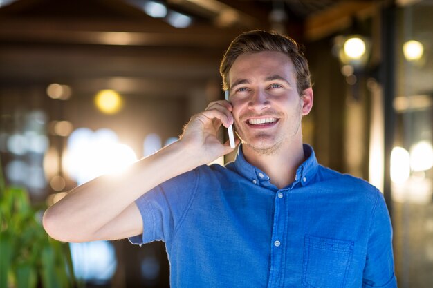 Happy man talking on mobile phone