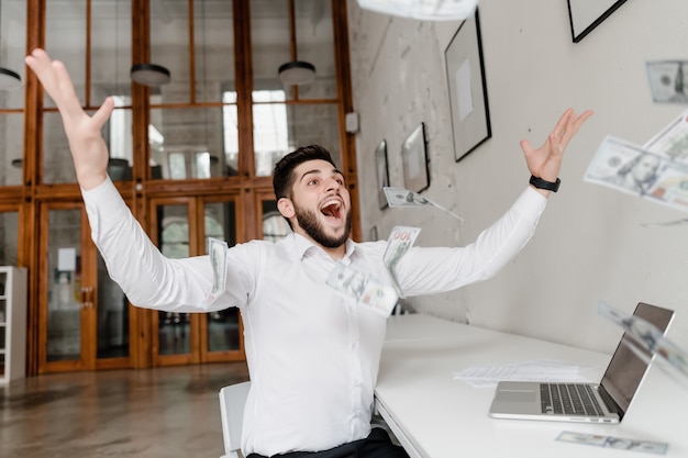 Happy man throwing money in the air