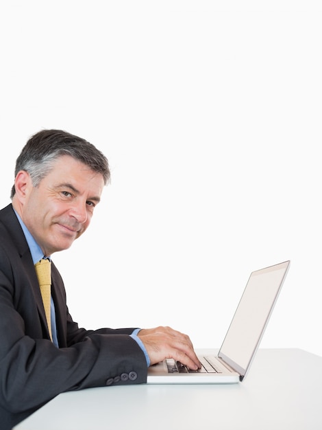 Happy man typing on laptop 