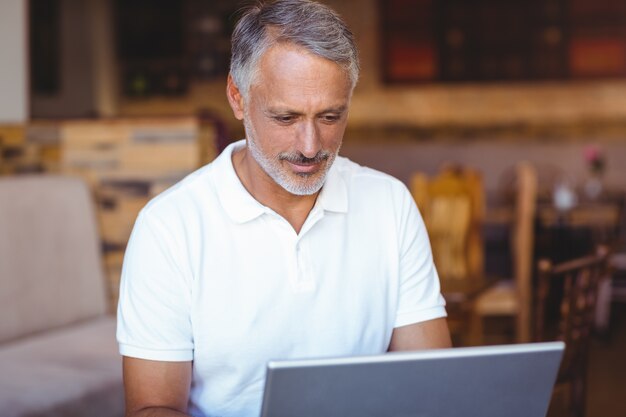  Happy man using his laptop computer