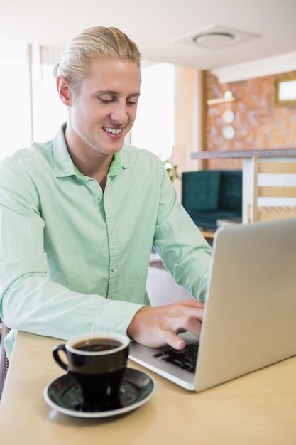 Happy man using laptop