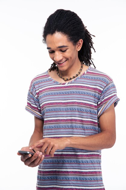 Happy man using smartphone isolated on a white wall