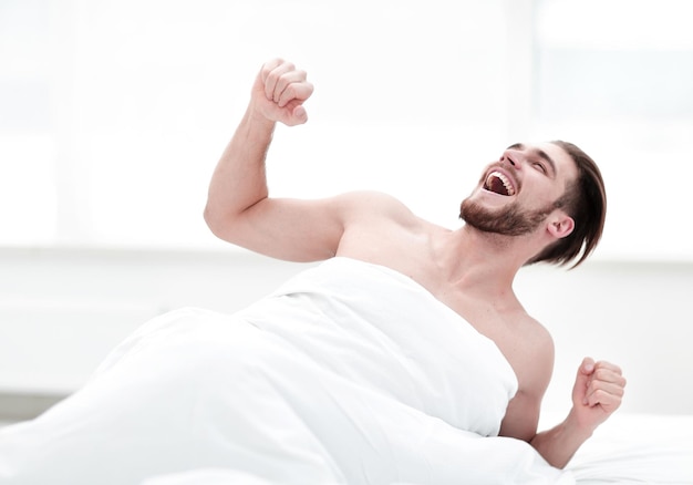 Happy man waking up in the morning