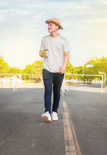 Happy man walking with glass of coffee happy young man walking with glass of coffee