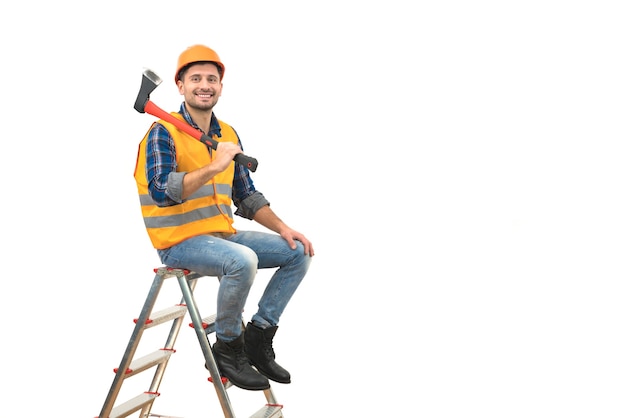 The happy man with an ax sitting on the ladder on the white background