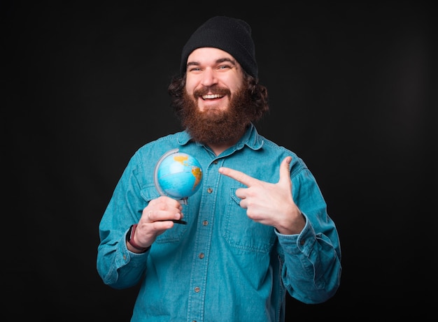  happy man with beard over dark background