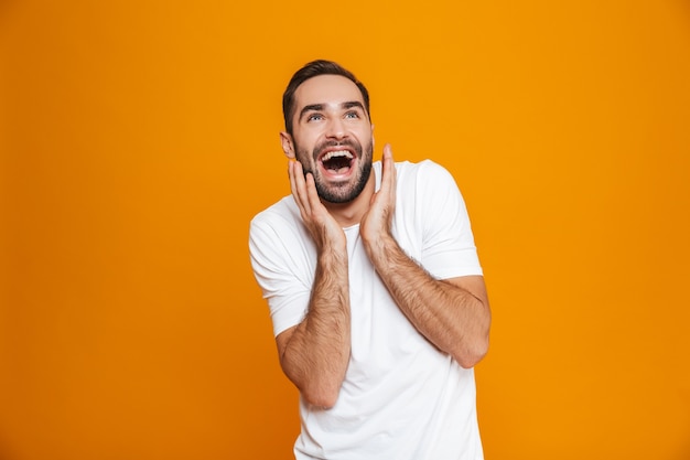 happy man with beard and mustache laughing while standing, isolated on yellow