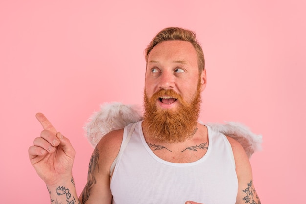 Happy man with beard and tattoos acts like an angel