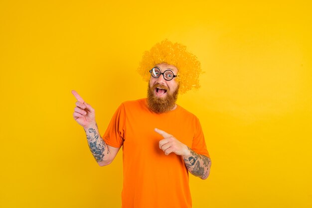 Happy man with beard yellow wig and glasses