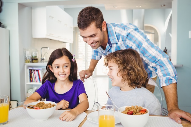 Happy man with children having breakfast