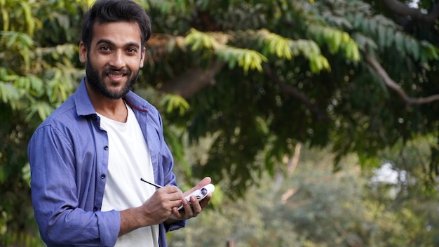 Happy Man With Notepad ready to write