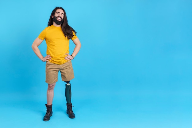 Happy man with prosthesis leg smiling while posing