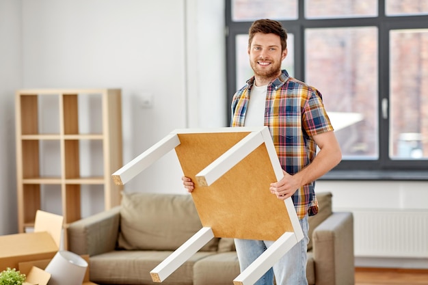 happy man with table moving to new home