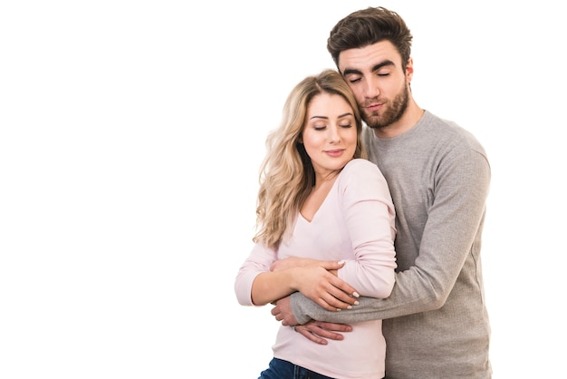 The happy man and a woman hug on the white background