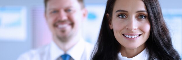 Photo happy man and woman office workers smiling at work. assistance in development investment projects. business plan develops an enterprise development strategy. calm businessmen during global pandemic