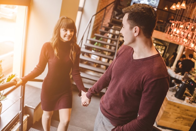 The happy man and the woman stand in the restaurant