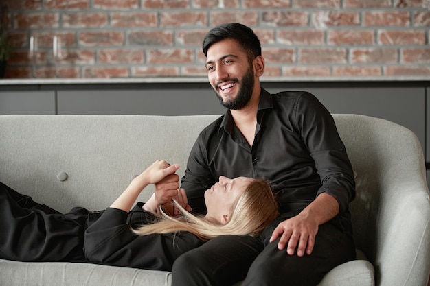 Happy married couple discussing something in a new apartment