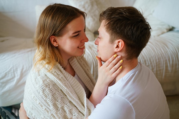 Happy married couple of millennial homeowners shot portrait husband and wife are sitting on the floo...