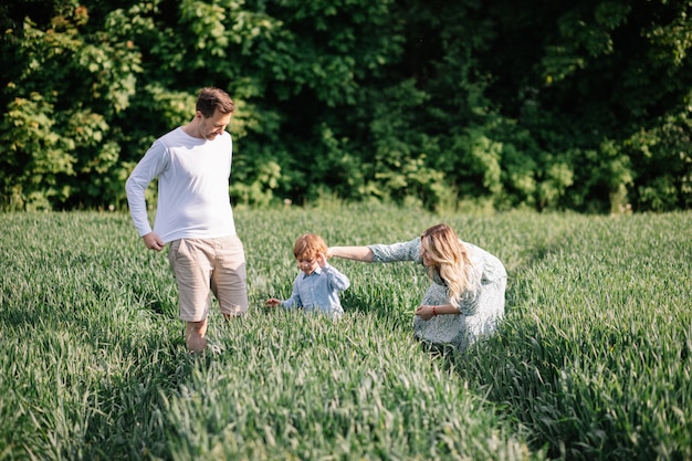 Happy married couple with one child have a great free time outdoors