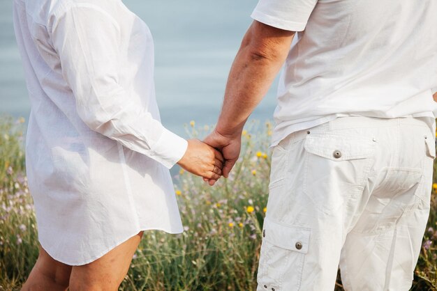 Happy mature couple pose on sunny day on the beach