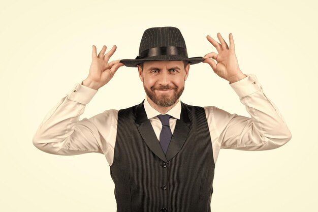 Happy mature guy in formalwear and retro hat isolated on white background elegance