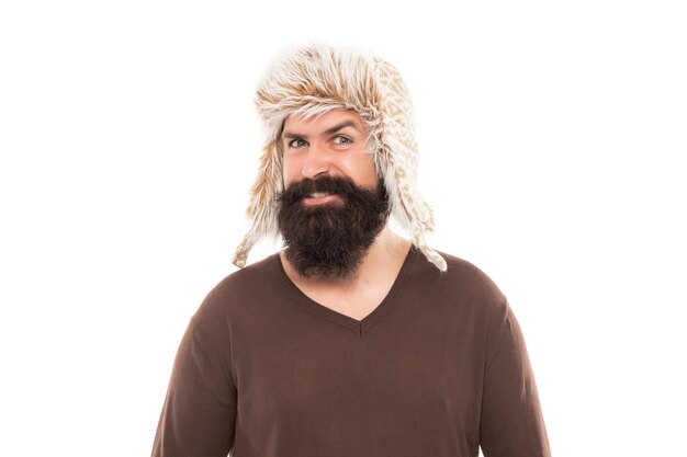 Happy mature guy with beard in earflape hat isolated on white background, winter