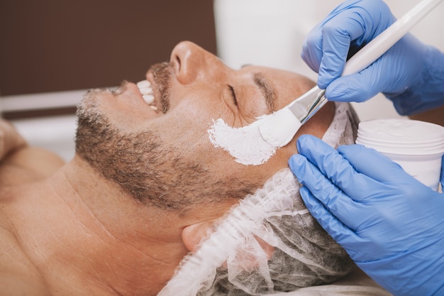 Happy mature man relaxing at spa center