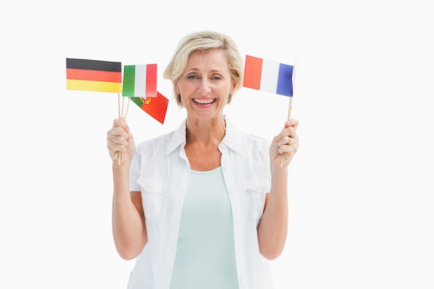 Happy mature woman holding flags