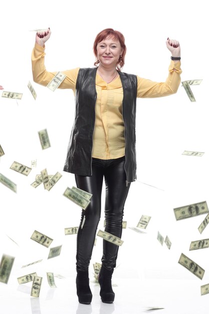 Happy mature woman standing under the money rain