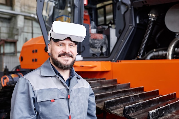 Happy mature worker of factory wearing vr headset and workwear