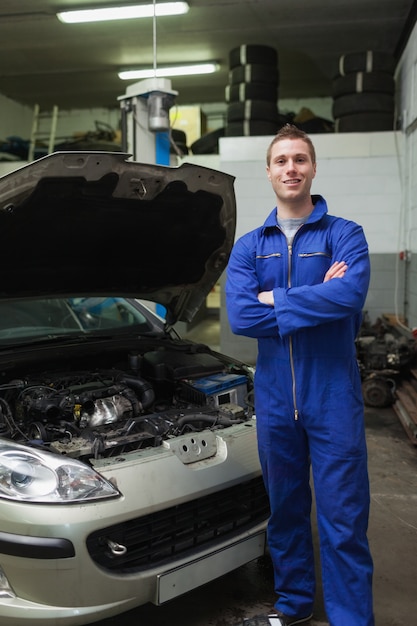 Happy mechanic by breakdown car